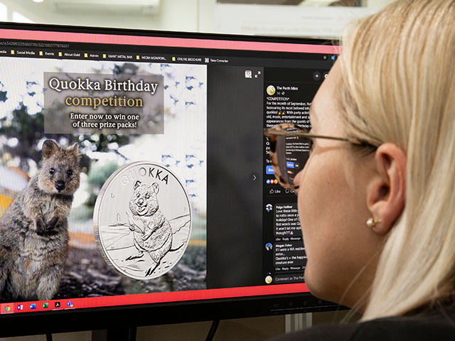 A staff member watching The Perth Mint in the news on a computer. 