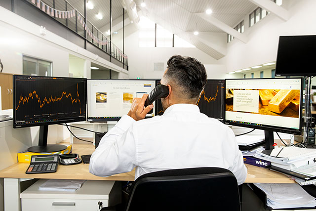 A treasury staff member on the phone at The Perth Mint. 