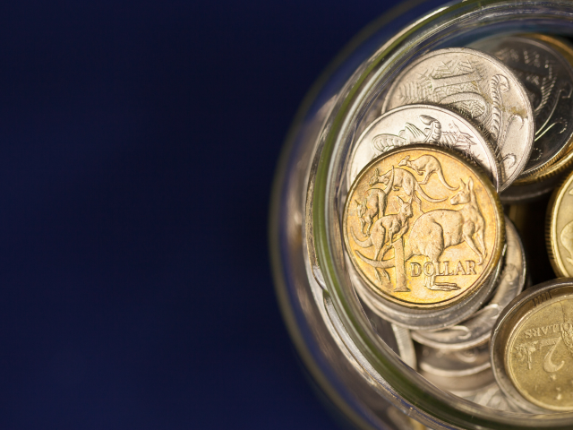 Australian gold and silver coins in jar