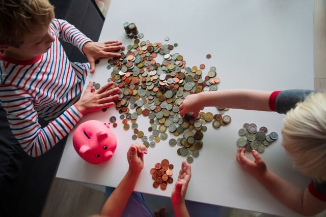 kids counting coins from their money bank