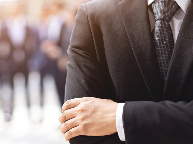 a torso of buisness man in a suit 