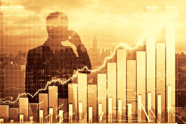businessman and gold graph