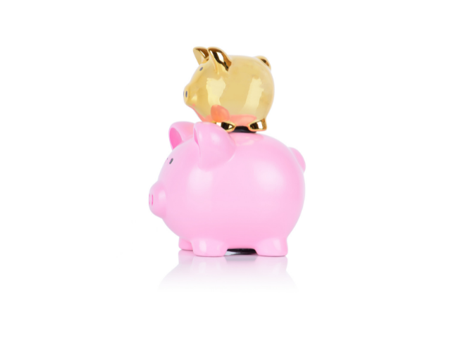 a pink piggy bank with a smaller gold piggy bank on top