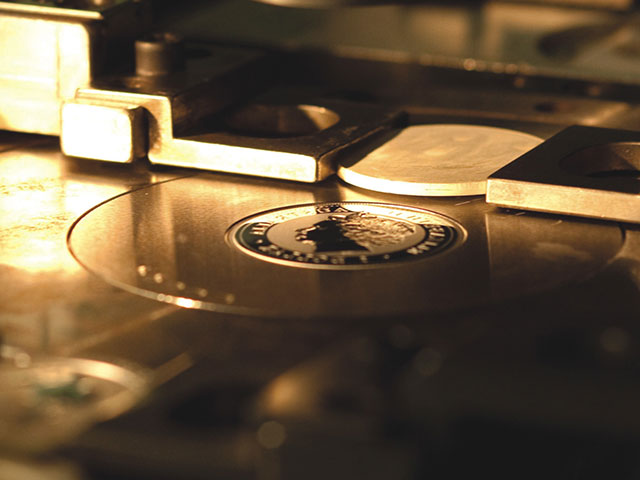 This is a coin in a machine press at The Perth Mint. 